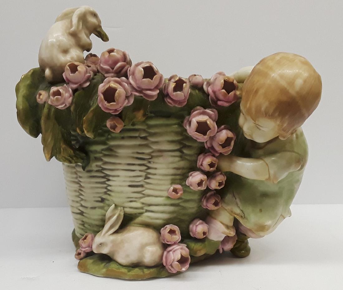 Antique Austiran Amphora Porcelain Planter: Amphora, And Austria Stamps. This Piece depicts a little girl with flowers and bunny rabbits. 7.5" x 8". Has Multiple Stamps on Underside