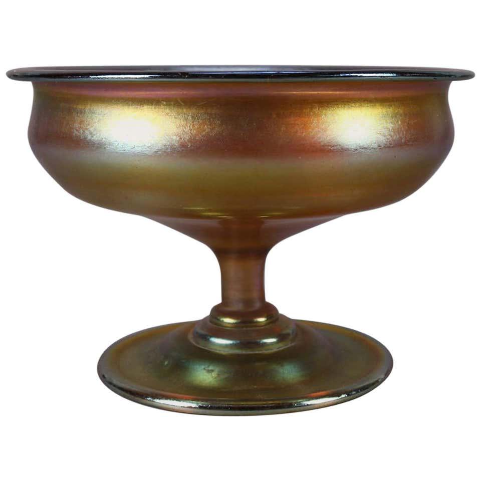 Antique American LC Tiffany Gold Favrile Art Glass: An Arts & Crafts Tiffany Studios petite antique footed bowl by Louis Comfort Tiffany in iridescent gold art glass in round form and seated on a round foot, signed on base L.C. Tiffany, circa 1900 Meas