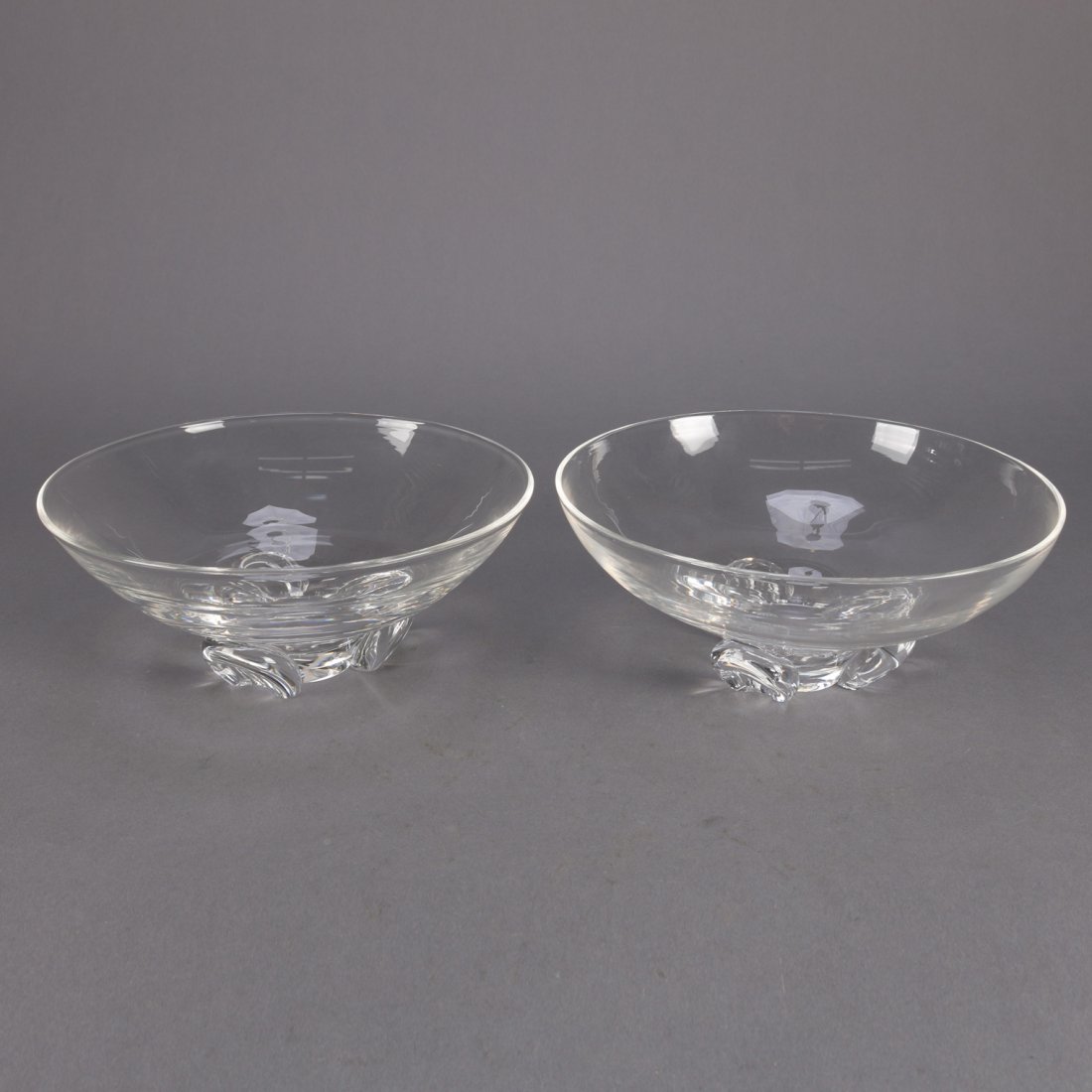 Set of 2 Steuben Crystal Bowls: Pair of art glass Steuben footed bowls, colorless, one signed and one unsigned, 20th century.Set of 2 Crystal Bowls Measures - 3.25" h, 8" op, 4" base***IN-HOUSE SHIPPING & DELIVERY QUICK QUOTES AVAIL