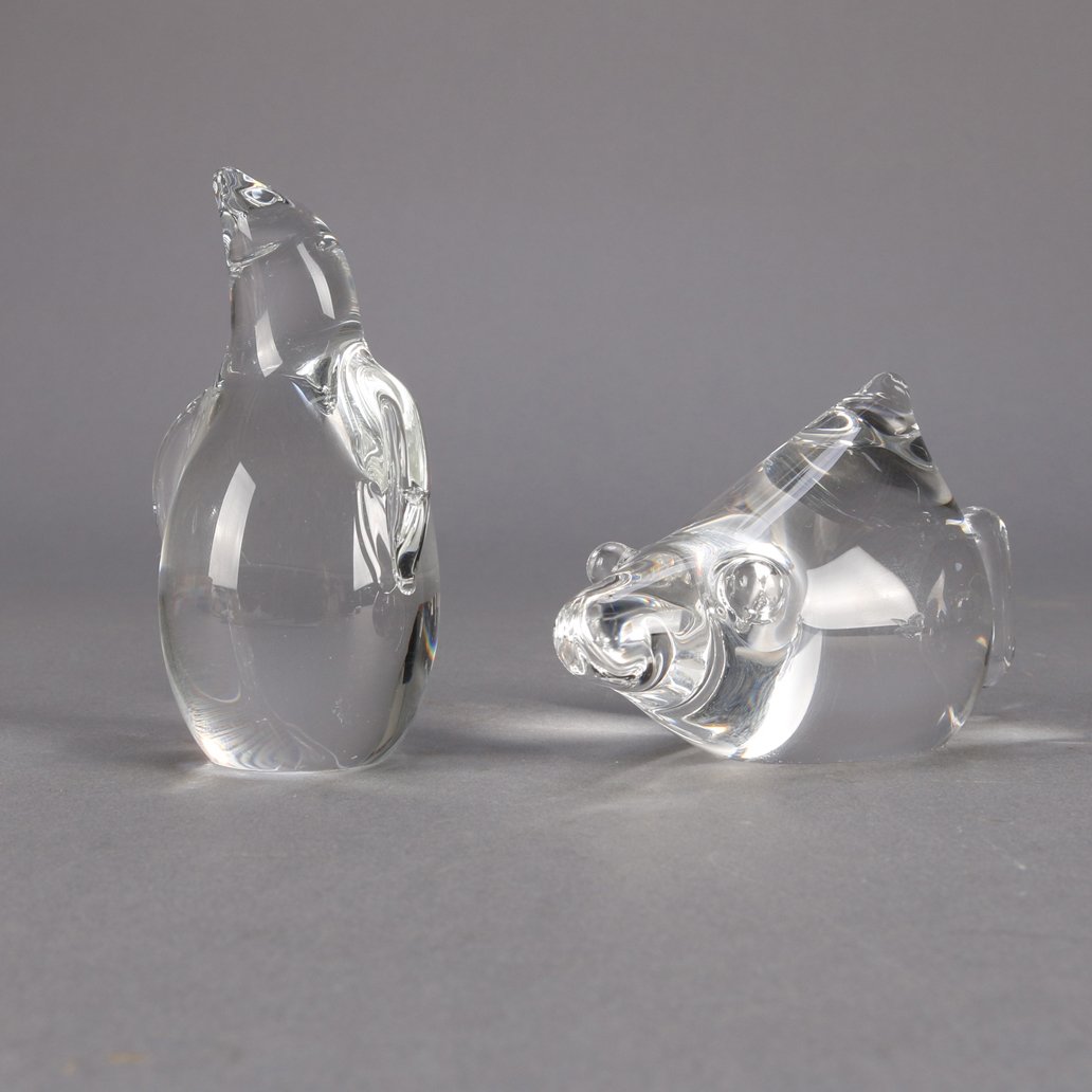 2 Signed Steuben Crystal Animals, Penguin & Fish: Signed Steuben art glass penguin and fish, colorless, 20th century.Measures - penguin: 3.75" h x 2.75" w x 2" d, fish: 2.75" h x 2.25" w x 4.5" d***IN-HOUSE SHIPPING & DELIVERY QUICK QUOTES AVAILABLE 