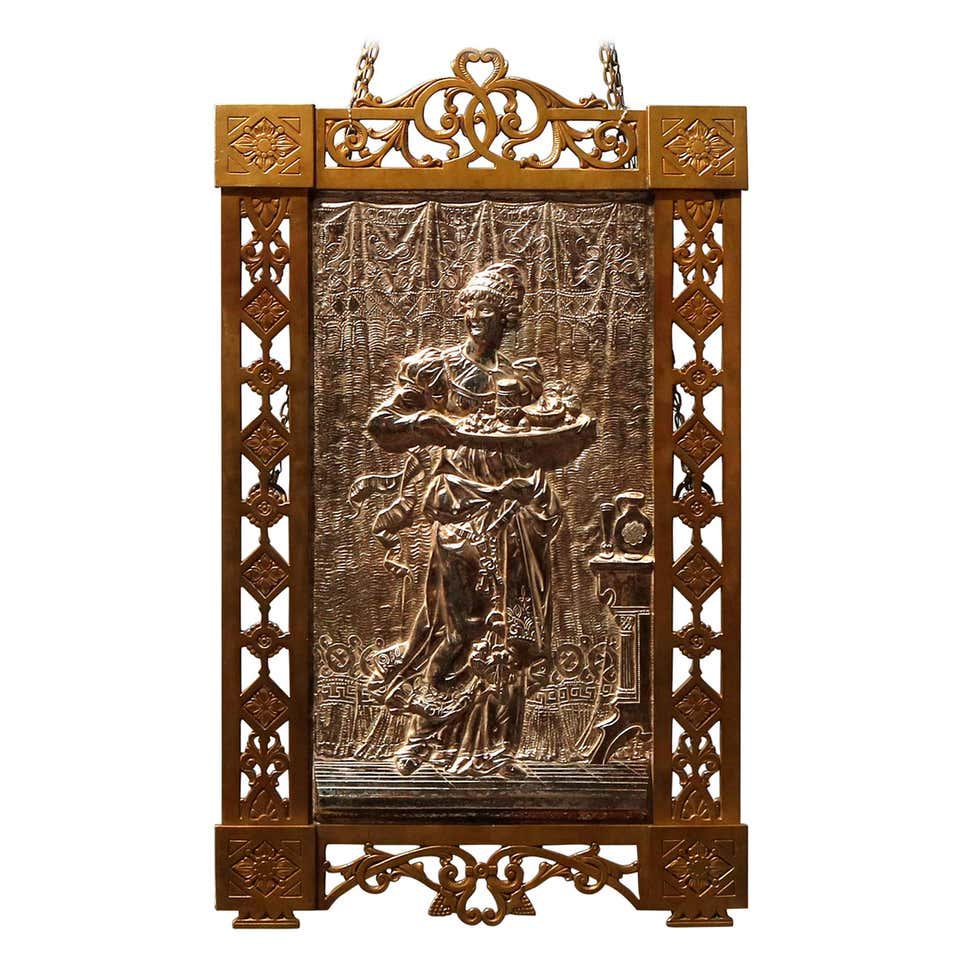 Aesthetic Movement High Relief Brass and Gilt Silver: Antique Aesthetic Movement high relief wall plaque offers silvered Classical scene of a woman with basket in countryside setting seated in pierced scroll and foliate frame, circa 1870 Measures - 22.75