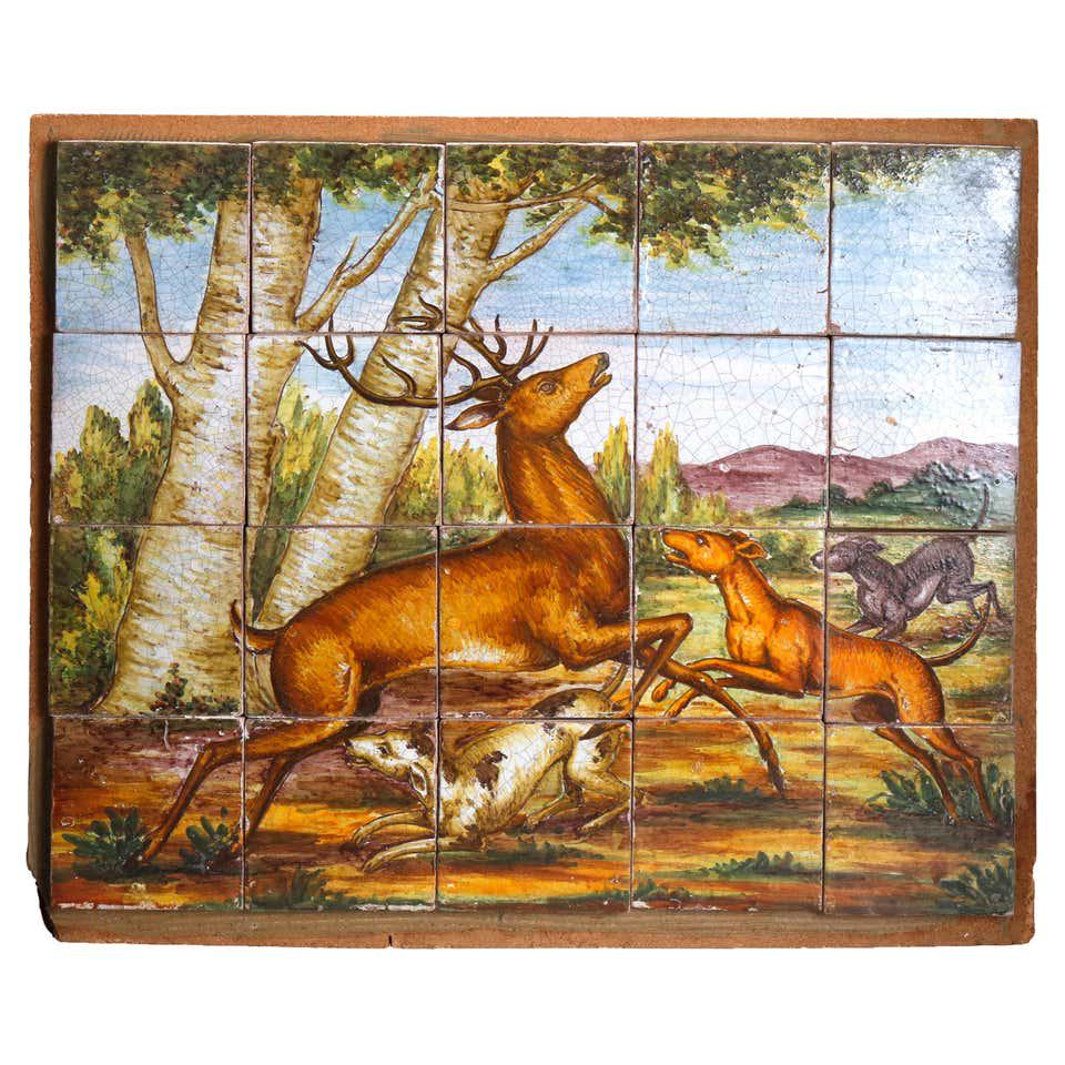 Italian Hand Painted Majolica Art Pottery Hunt Scene: An antique Italian Majolica pottery tile grouping depicts hand painted hunt scene with deer and dogs in woodland setting, mounted on board, circa 1880. Measures: 24.5" H x 29.25" W x 1.25" D. ***IN-HO