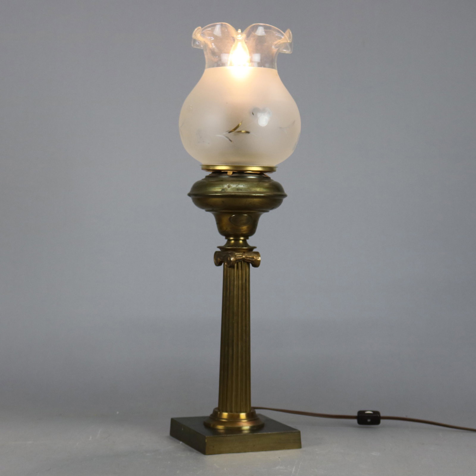 Antique Classical Cornelius & Co. Solar Lamp: An antique Classical solar oil lamp by Cornelius & Co. offers font with maker label surmounting reeded column and square base, ruffled rim frosted shade with etched decoration, electrified, circa 1890