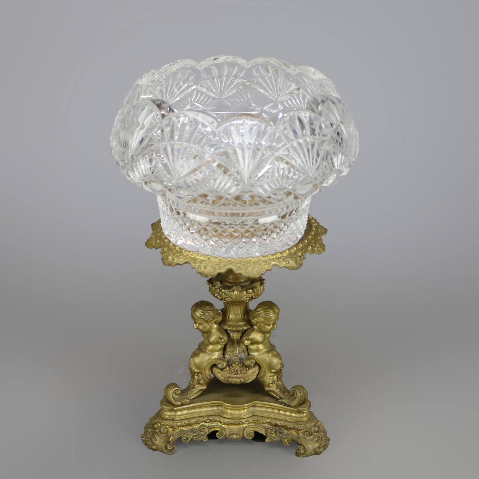 Antique French Rococo Figural cherub Bronze Compote: An antique French Rococo figural compote offers crystal bowl surmounting bronze base with cherubs, scroll and foliate elements, c1870. Measures - 13.75"H X 6.25" BASE, 8.5" DIAM BOWL ***IN-HOUSE SHIPP