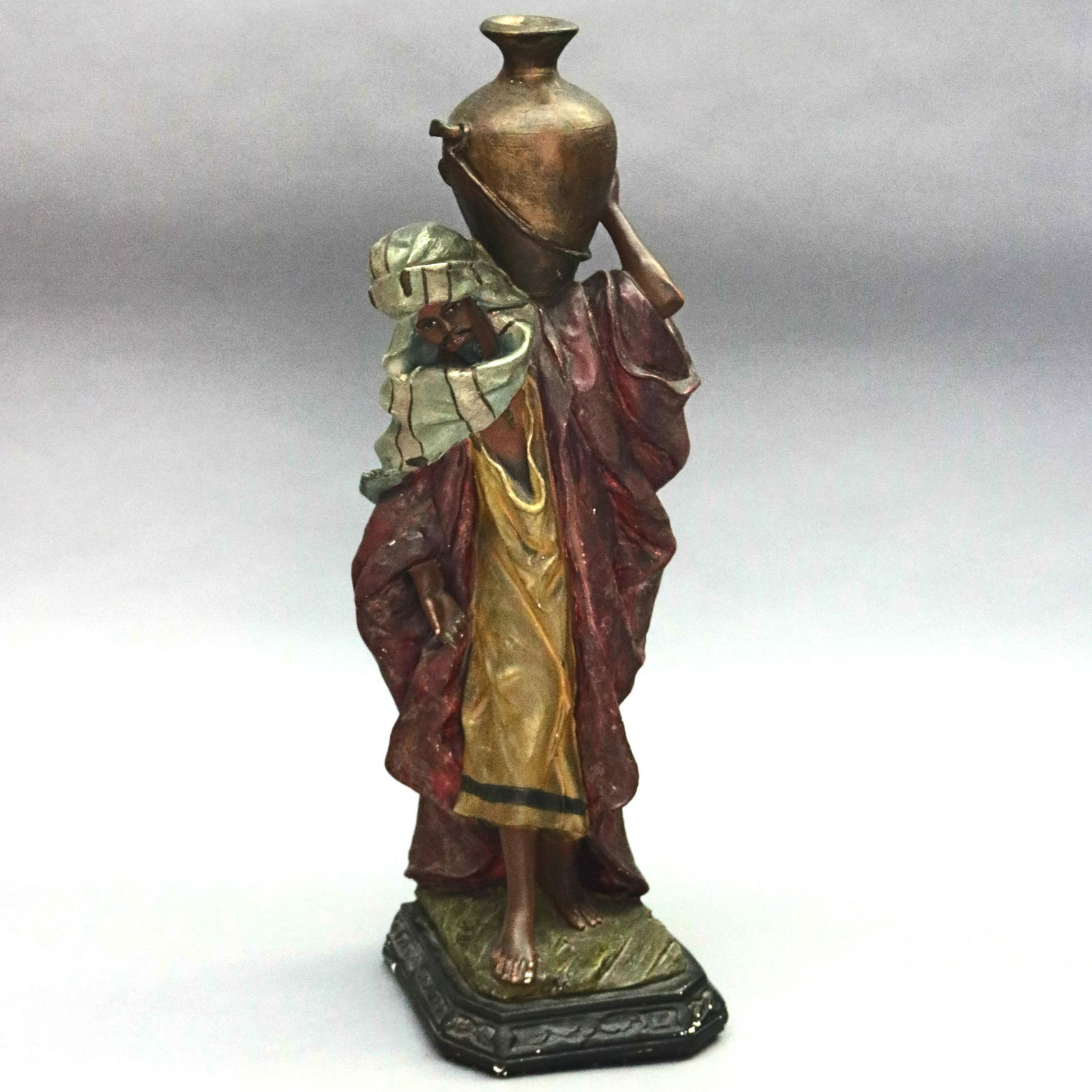 Antique Orientalist Persian Polychrome Chalkware Sculpt: An antique Persian Orientalist sculpture offers polychromed chalkware construction and depicts man carrying water vessel, c1890. Measures- 25" H x 7.5" Diam. ***IN-HOUSE SHIPPING & DELIVERY QUICK QUOT