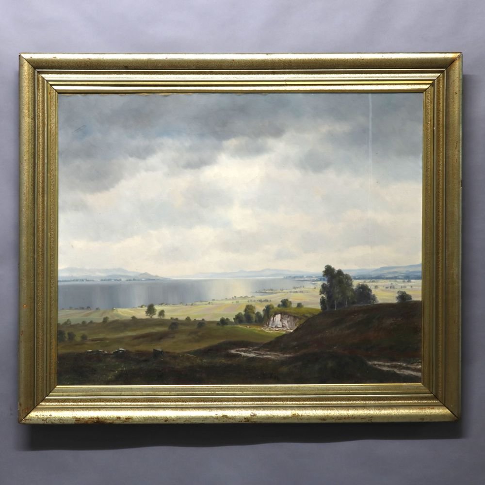 Antique Painting, Landscape, manner Hudson River School: An antique oil on canvas landscape painting in the manner of Hudson River School depicts lake scene with mountainous background and country road in foreground, seated in giltwood frame, c1930. Measure