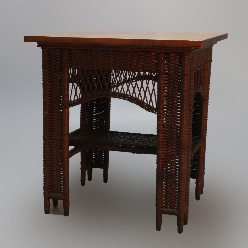 Antique Heywood Wakefield Arts & Crafts Wicker & Oak: Antique Arts and Crafts lamp table by Heywood Wakefield offers oak frame with wicker panels and shaped skirt with lower display shelf , without label, C1910. Measures- 30" H x 28" W x 24" D. ***IN-HOU
