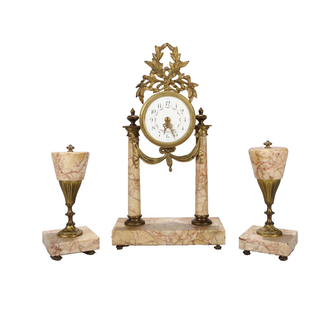 French Louis XVI Rouge Marble & Bronze Garniture Set: An antique French Louis XVI garniture set offers central clock having foliate cast bronze crest over works having flanking rouge marble column supports with cast bronze draped swag and two complementi