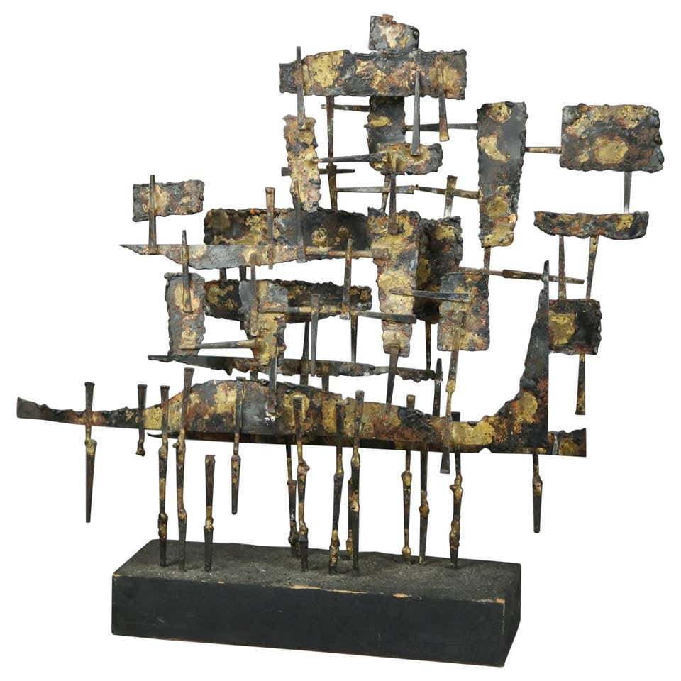 Mid-Century Modern Brutalist Metal Sculpture, c 1960: A Mid-Century Modern Brutalist sculpture offers metal construction with raised geometric elements, unsigned, circa 1960. Measures: 17.75" H x 18.5" W x 3.75" D. ***IN-HOUSE SHIPPING & DELIVERY QUICK Q
