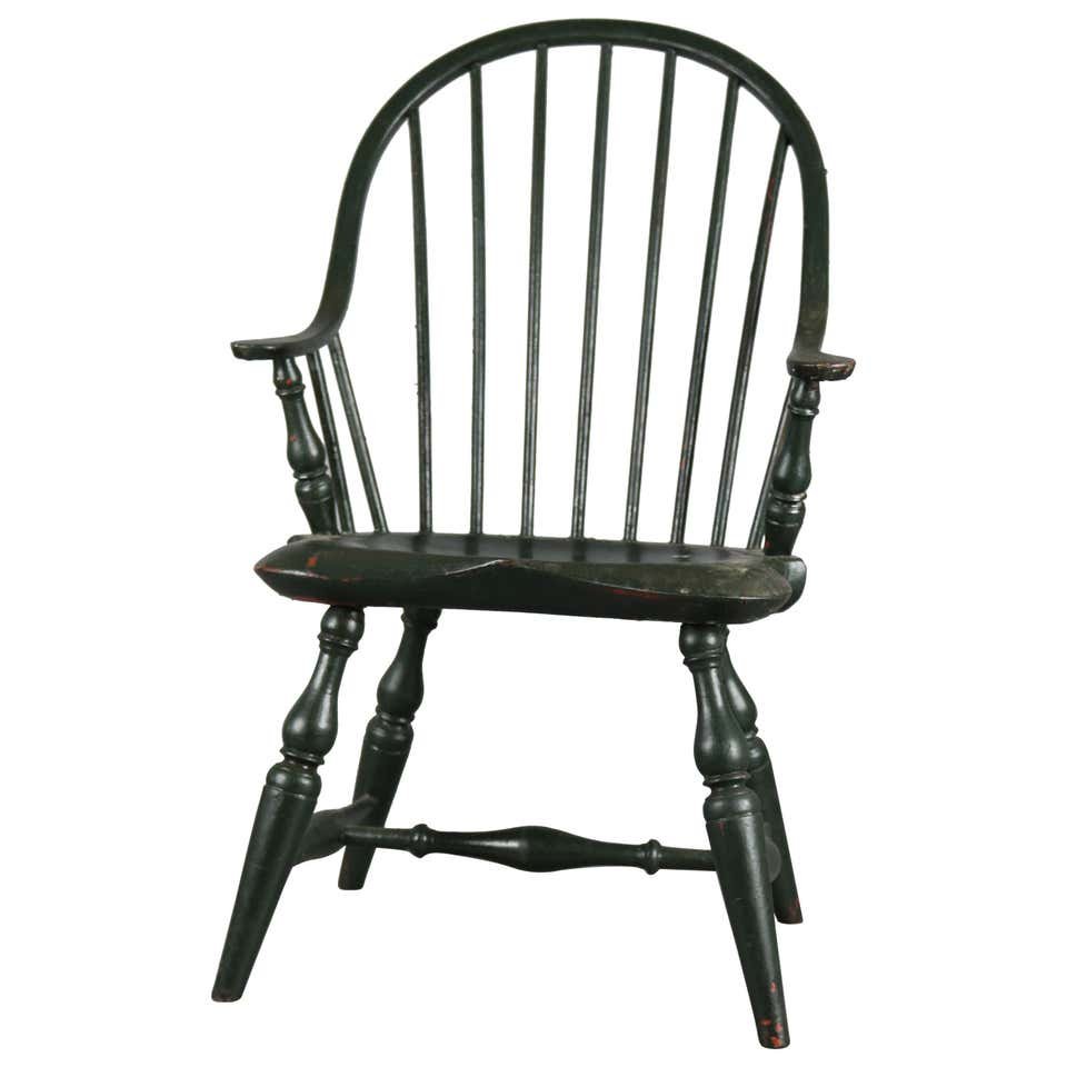 Antique Bow Back Windsor Childs Arm Chair, 20th C: An antique bow back Windsor child's armchair offers spindle back with continuous arm over seat raised on turned legs, grain painted, 20th century. Measures- 26.5" H x 14.25" W x 13.5" D. ***IN-HOUSE S