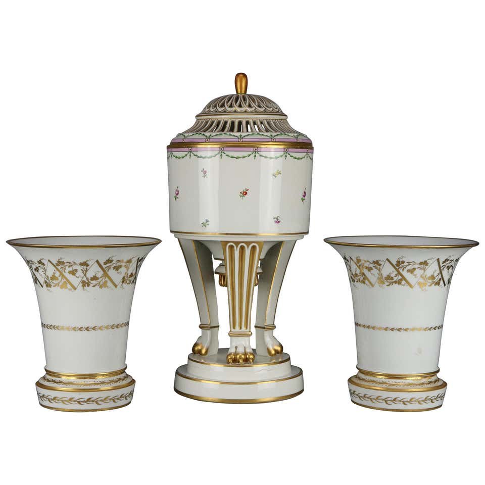 Lg Neoclassical Royal Vienna Porcelain Garniture Set: An antique oversized Neoclassical porcelain garniture set offers paint and gilt decorated Austrian Royal Vienna central urn with reticulated lid and raised on three convex legs, beehive maker mark on