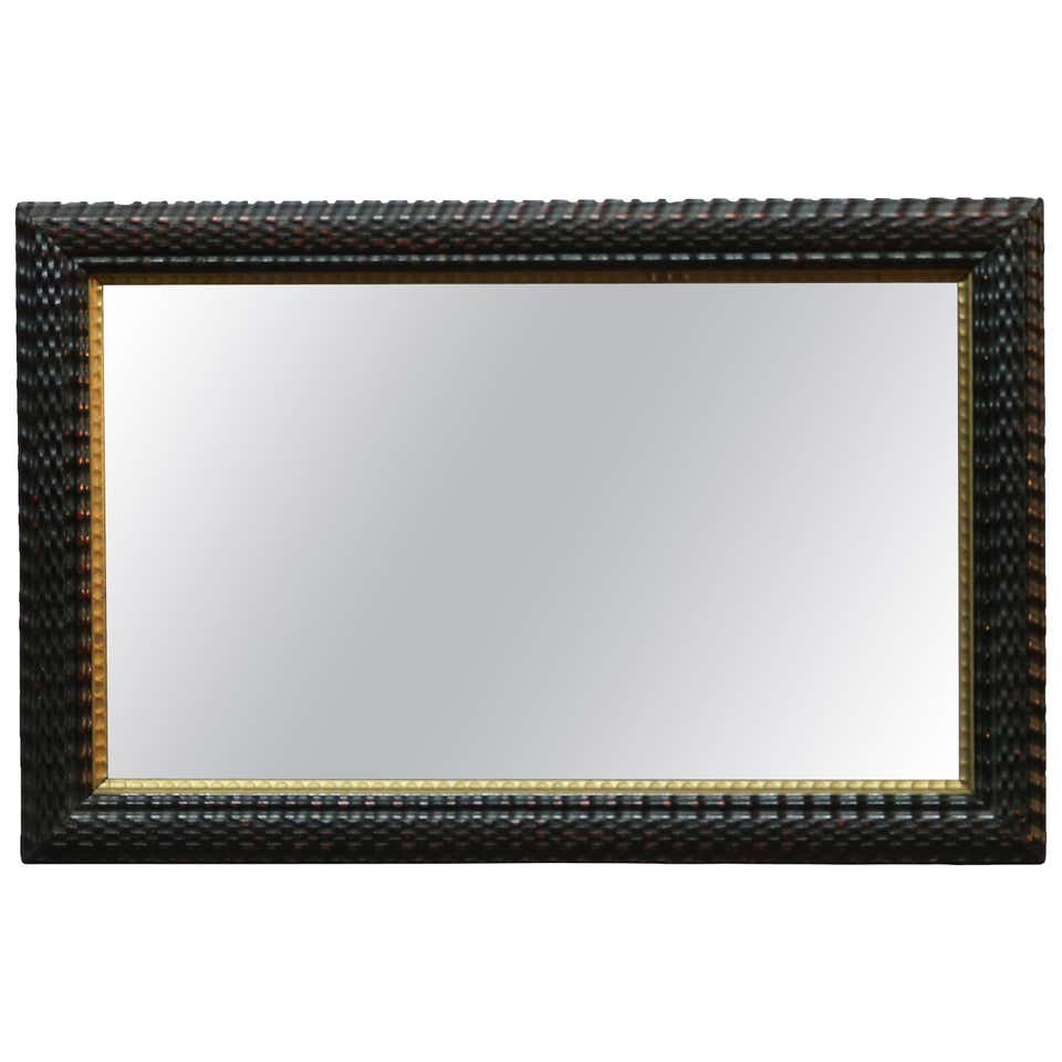 Parcel Gilt Ebonized Ripple Wood Wall Mirror, 19th C: An antique wall mirror offers ebonized carved ripple wood frame with gilt inner trim, 19th century. Measures: 18.25" H x 28.25" W x 1.5" D. ***IN-HOUSE SHIPPING & DELIVERY QUICK QUOTES AVAILABLE UPON 