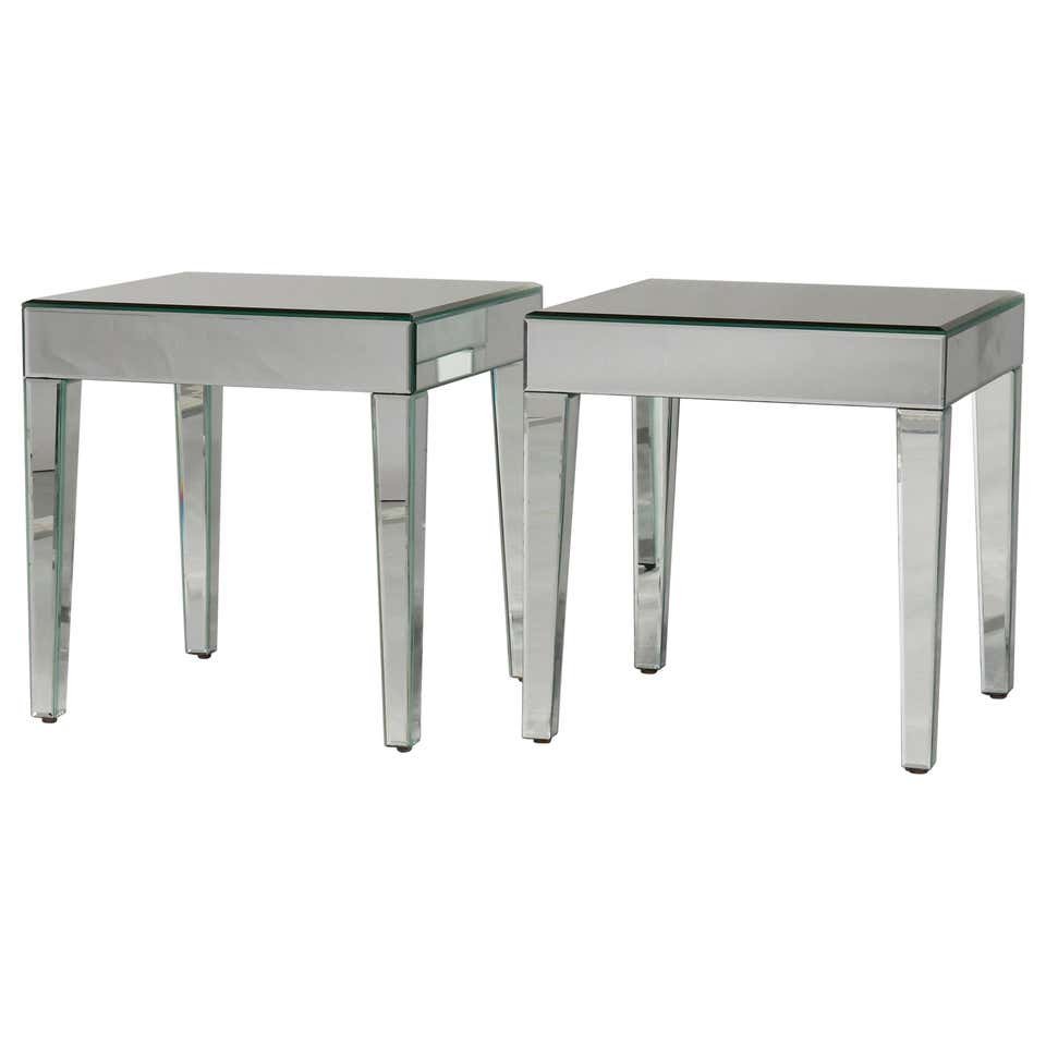 Pair of Mid-Century Modern Mirrored Glass Side Tables: A pair of Mid-Century Modern side tables offer mirrored construction raised on tapered straight legs, circa 1960. Measures: 19.25" height x 18.75" diameter. ***IN-HOUSE SHIPPING & DELIVERY QUICK QUOTE
