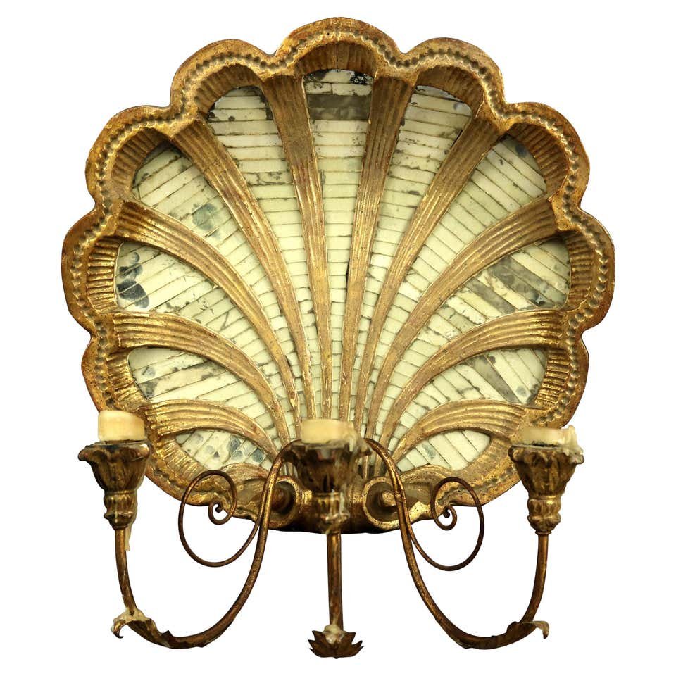 Large French Giltwood Mirrored Shell Wall Candelabra: An antique and large French wall candelabra offers giltwood plate in shell form having three s-scroll arms terminating in foliate form candle receivers, 20th century. Measures: 24" H x 19.5" W x 11.75