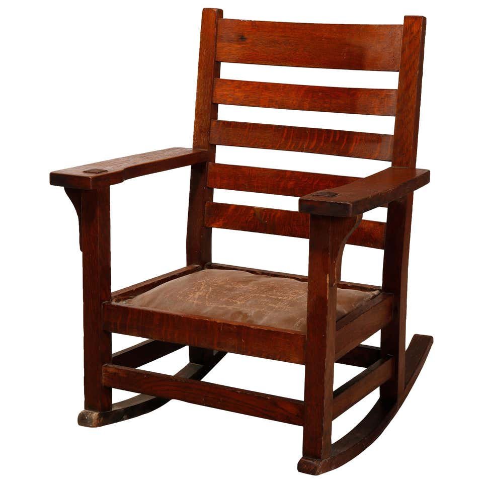 Arts & Crafts Gus Stickley School Mission Oak Rocker: An antique Arts & Crafts Mission rocker in the manner of Gustav Stickley offers oak construction with slat back, circa 1910. Measures: 35" H x 27.25" W x 25" D. ***IN-HOUSE SHIPPING & DELIVERY QUICK Q