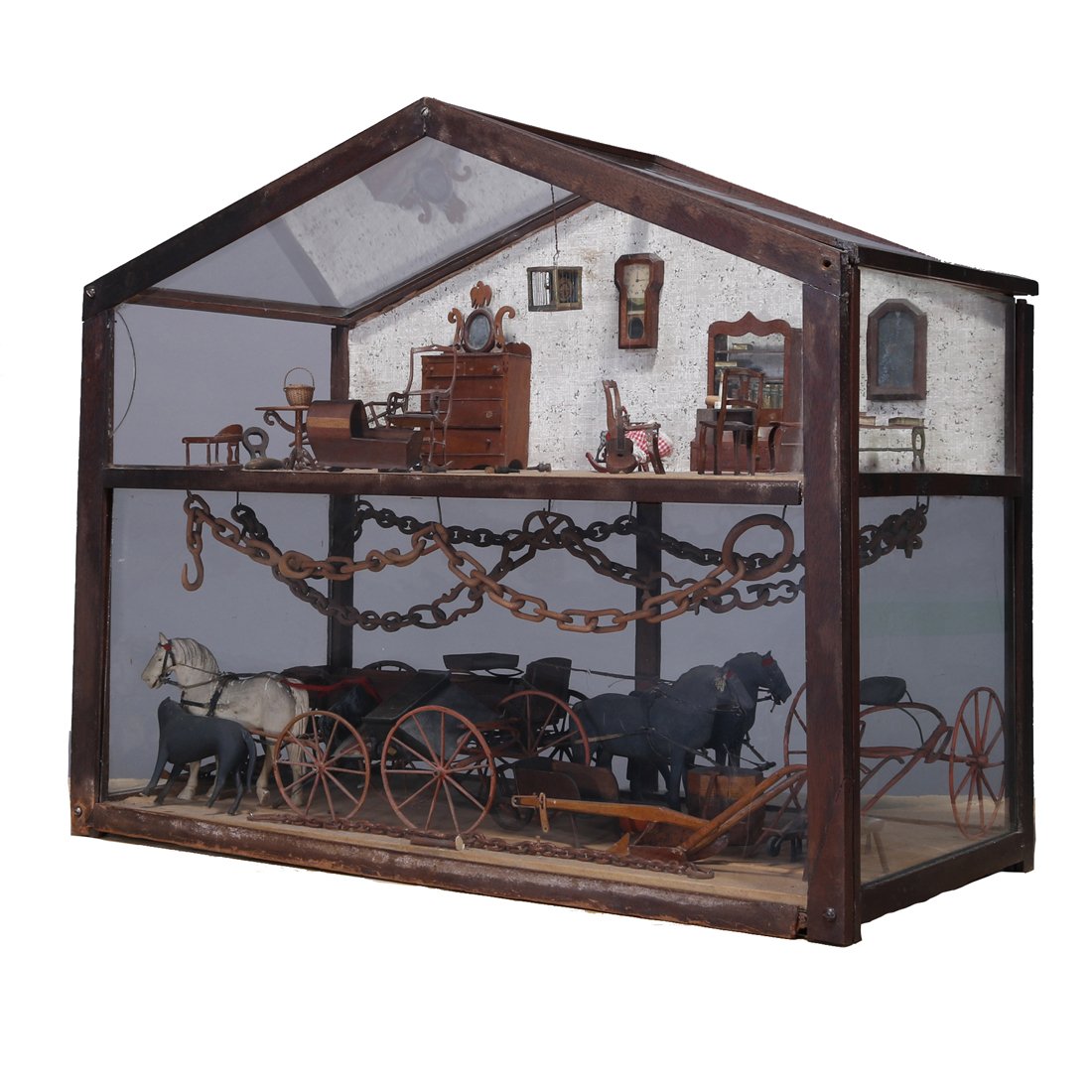Folk Art Diorama w/Hand Carved Wood Figures, c1850: An antique Folk Art diorama depicts carriage house with glass panels in wood frame and having upstairs living quarters with hand carved wood miniature furniture and lower room with horses, wood chain 