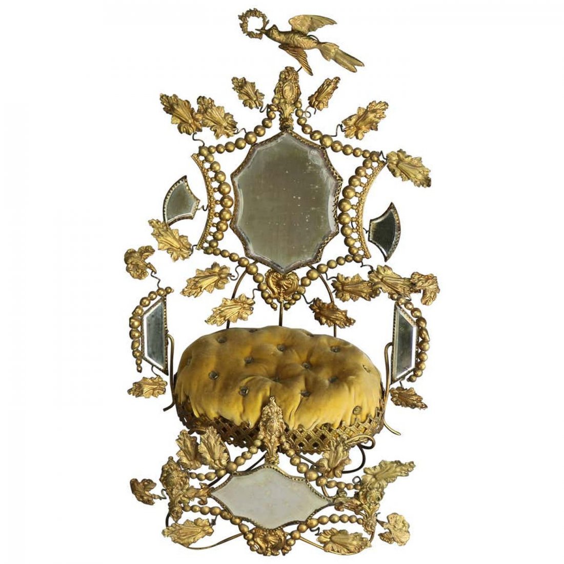 Large Victorian Whimsical Mirror Miniature Pin Cushion: An antique and large Victorian whimsical miniature throne settee pin cushion offers gilt brass frame with central mirror and button cushion, circa 1880. Measures: 21" H x 11.5" W x 6.75" D. ***IN-HOUS