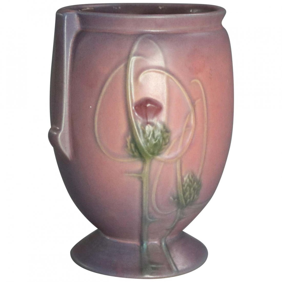 Vintage Roseville Art Pottery Futura Thistle Vase: An Art Deco art pottery vase by Roseville of the Futura line offers double handled and footed vessel with thistle pattern in rare matte mauve and purple glaze, unmarked, circa 1930. Measures: 8" H x 6