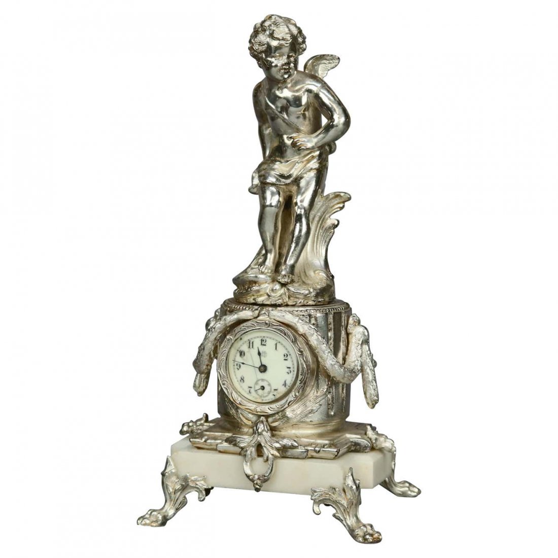 Neoclassical Jennings Silver Gilt/Marble Figural Clock: An antique neoclassical figural mantel clock by Jennings Brothers offers cast and silver gilt sculptural cherub surmounting clock with foliate frame, porcelain dial and marble base raised on pay feet,