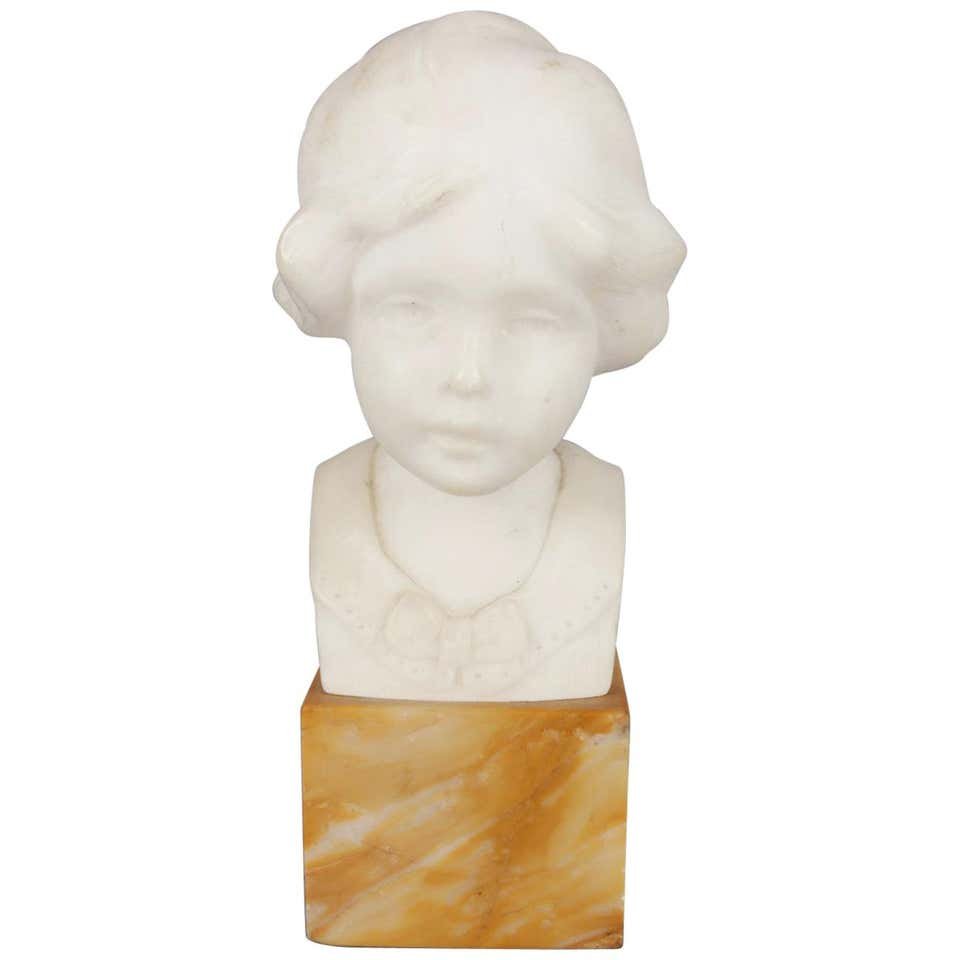 Hand-Carved Alabaster Portrait Bust Sculpture of Girl: Hand-carved alabaster portrait sculpture of young girl, en verso signed Greiwer, seated on marble Stand, circa 1900.Measures: 8\" H x 3.5\" W x 4.5\" D overall, 2.75\" x 2.75\" base. *** NOTE - Onsite