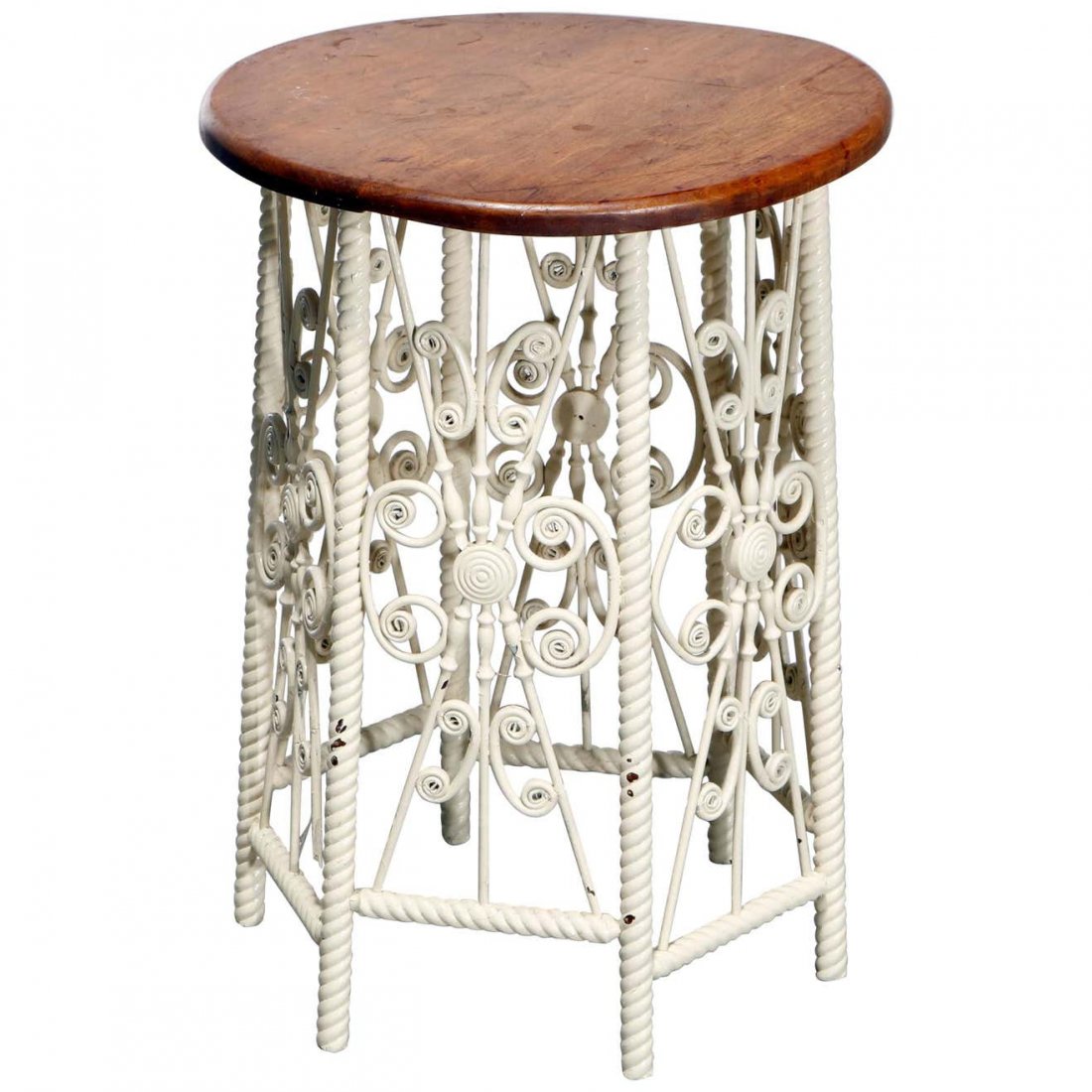Heywood Wakefield (attr.) Wicker Plant Stand, C1900: An antique plant stand attributed to Heywood Wakefield offers round wood display over faceted base having carved twist legs and scroll wicker decoration, base with original white paint, c1900. Measure