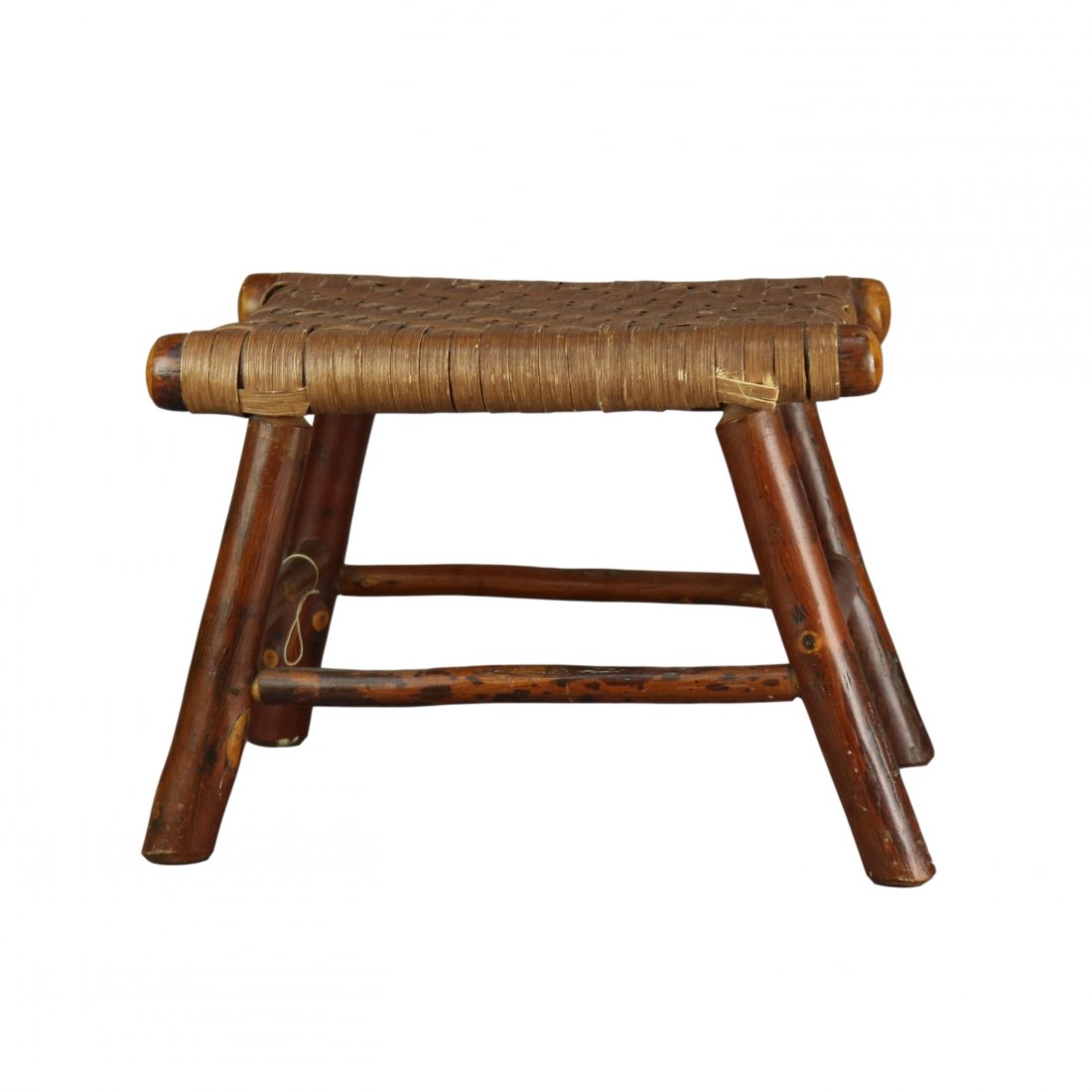 Rustic Adirondack Old Hickory School Footstool, 20thC: An antique rustic Adirondack footstool in the manner of Old Hickory offers branch form frame with woven thatch seat, 20th century. Measures: 12" H x 17.5" W x 12" D . *** NOTE - Onsite retrieval is al