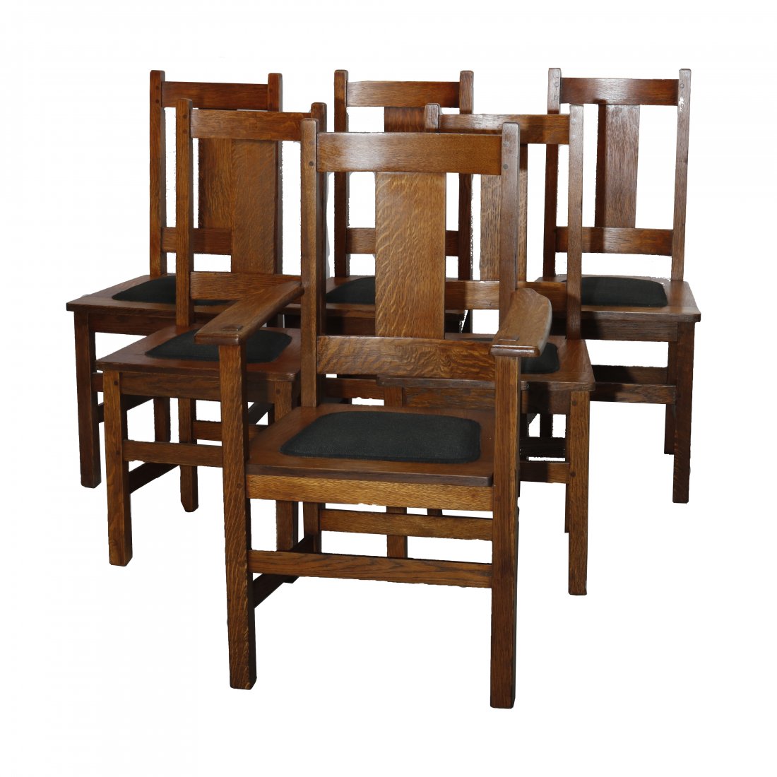 Six Arts & Crafts Oak Limbert Dining Chairs, c 1910: A set of six antique Arts and Crafts dining chairs by Limbert offer quarter sawn oak construction with slat backs and includes one arm chair and five side chairs, c1910. Measures: 39" H x 24" W x 20" 