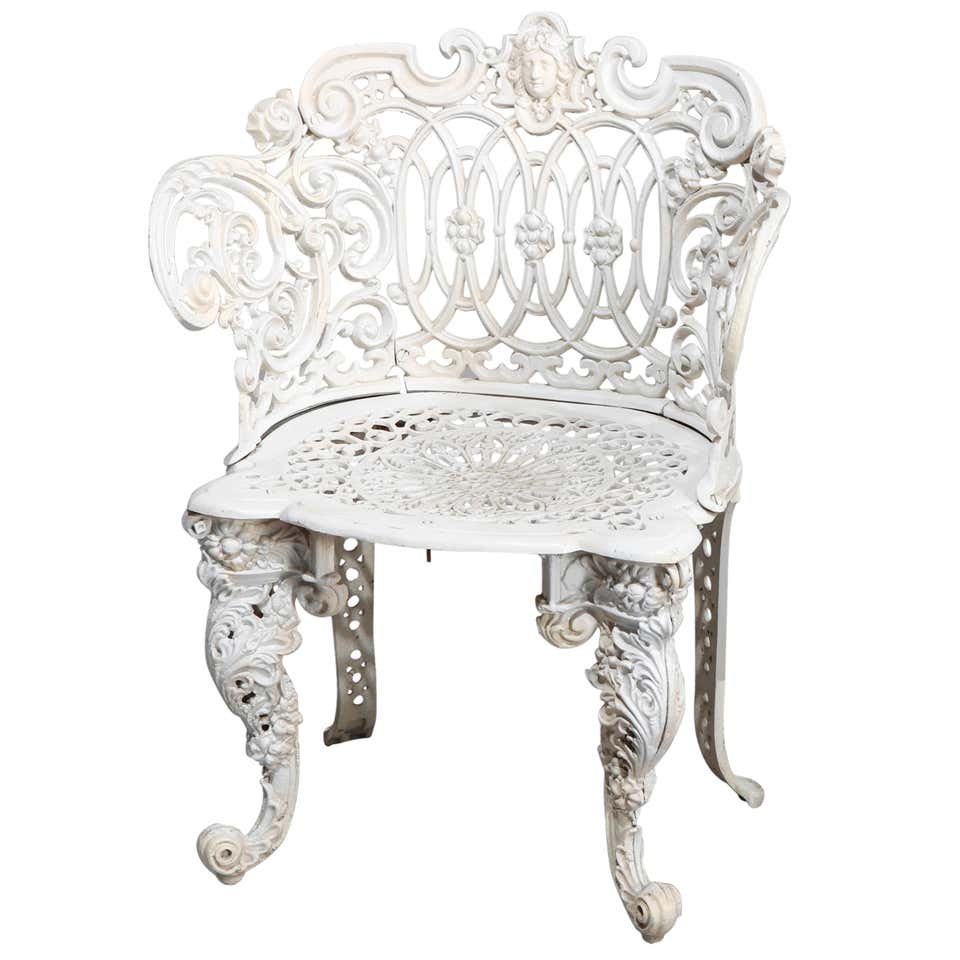 Renaissance Revival Style Figural Jenny Lind Armchair: A Renaissance Revival style figural garden armchair offers cast aluminum construction with scroll and foliate back having Jenny Lind crest and scroll form arms surmounting pierced seat and raised on f