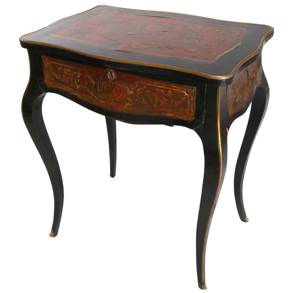 Antique Napoleon III Boulle Ebonized Sewing Stand c1870: An antique Napoleon III Boulle and Tortoise shell sewing stand offers ebonized case with top having mirrored interior opening to compartments surmounting lower drawer and raised on cabriole legs, gilt