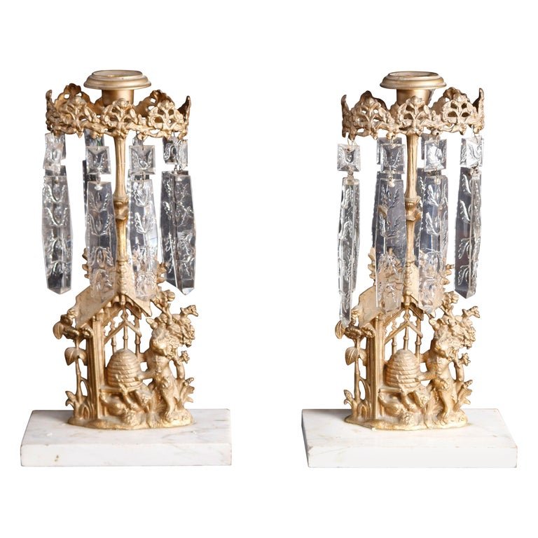 Pair of Girandole Crystal and Gilt Metal Candelabra with Beehive, c1890: An antique pair of girandole candle sticks offer cast gilt metal with countryside scene having beehive, seated on marble base, crystal prisms throughout, c1890Measures- 14.5" H x 4.25" W x 4.25" D.***