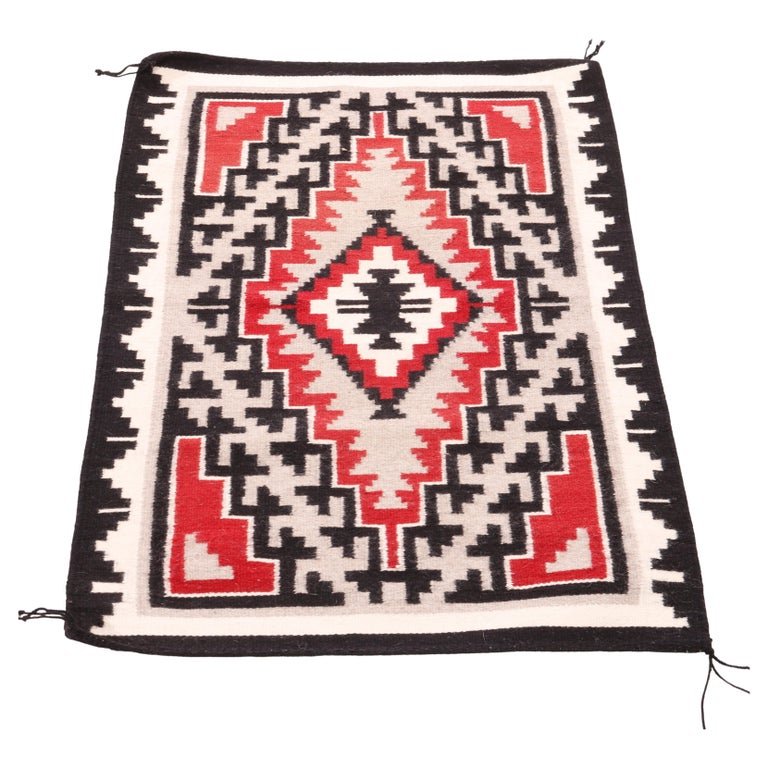 Southwestern American Indian Navajo Eye Dazzler Hand Woven Wool Rug, 20th C: A Southwestern Native American Indian Navajo rug offers hand woven wool construction with design having central eye dazzler diamond, 20th centuryMeasures- 40''L x 26.25''w x .5''d. *** OPTIONAL SHIPPI