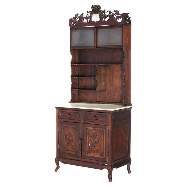 Antique Chinese Carved Hardwood & Marble Display Cabinet Circa 1920: An antique Chinese display cabinet offers hardwood construction with pierced foliate crest over shelving unit which surmounts lower marble top case with two upper shelves and double foliate carved doo