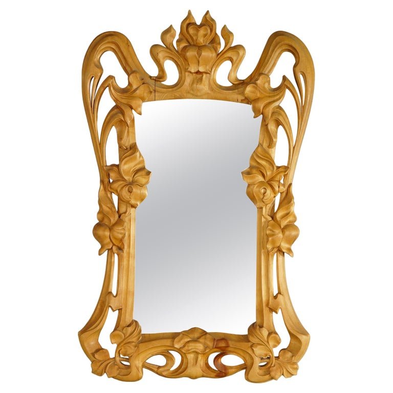 Art Nouveau Foliate Carved Fruitwood Wall Mirror, 20th C: An Art Nouveau wall mirror offers carved and pierced fruitwood frame with foliate and floral elements, 20th century.Measures- 42.5''H x 25.75''W x 2.5''D. *** OPTIONAL SHIPPING & DELIVERY - While onsi