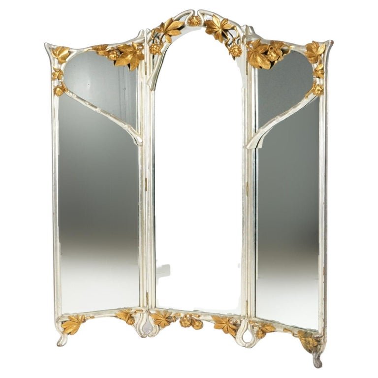 Antique French Art Nouveau Three-Panel Giltwood Dressing Mirror, circa 1920: An antique French Art Nouveau dressing mirror offers giltwood construction with branch and floral form tri-fold frame raised on cabriole legs; circa 1920.Measures- 68.5''H x 65.5''W x 2.25''D.. *** OP