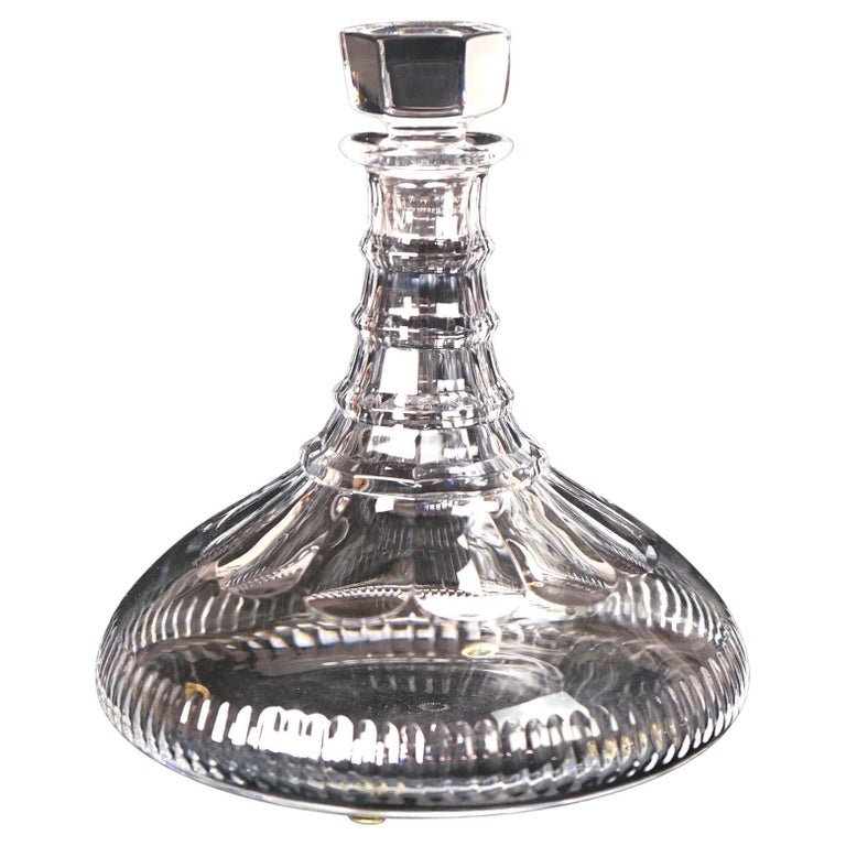 William Yeoward Crystal Glass Spirits Decanter & Stopper, 20th C: A crystal spirits decanter by William Yeoward offers crystal construction with banded neck and stopper, maker mark on base as photographed, 20th century. Measures - 8.75"h x 7.75"diam. *** OPTIONAL SH