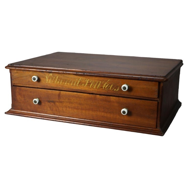 Antique Coats School Cherry Country Store Spool Cabinet Circa 1900: An antique country store spool cabinet in the manner of Coats offers cherry construction with two drawers, one with gilt lettering, c1900. Measures - 7.75"h x 23.5"w x 16.25"d. *** OPTIONAL SHIPPING &