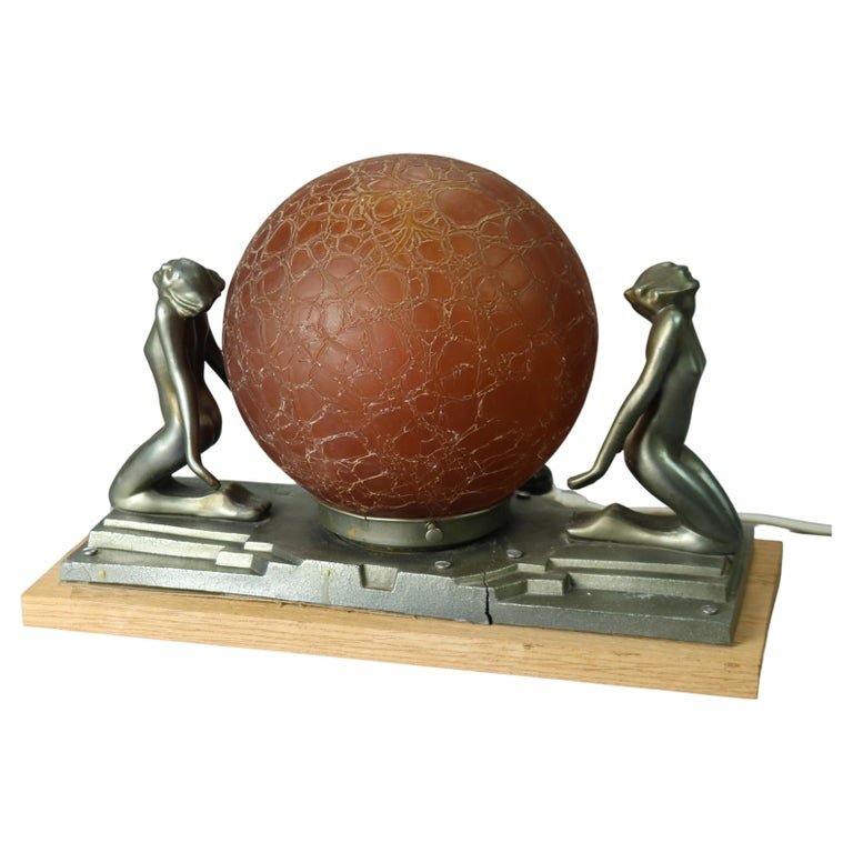 Antique Art Deco Frankart Figural Table Lamp with Nudes Circa 1920: An antique Art Deco figural Frankart table lamp offers cast metal base having two female nudes holding a central art glass globe, c1920Measures - 10"h x 15.25"w x 7.25"d. *** OPTIONAL SHIPPING & DELIV