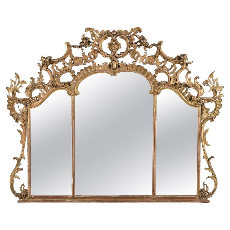 Antique 18th/19thC French Louis XIV 54" Triptych Giltwood Over Mantel Mirror: An antique French Louis XIV over mantel mirror offers giltwood construction in triptych form with pierced scroll and foliate frame, 18th/19thC. Measures - 54"h x 66"w x 4"d. *** OPTIONAL SHIPPING & DE