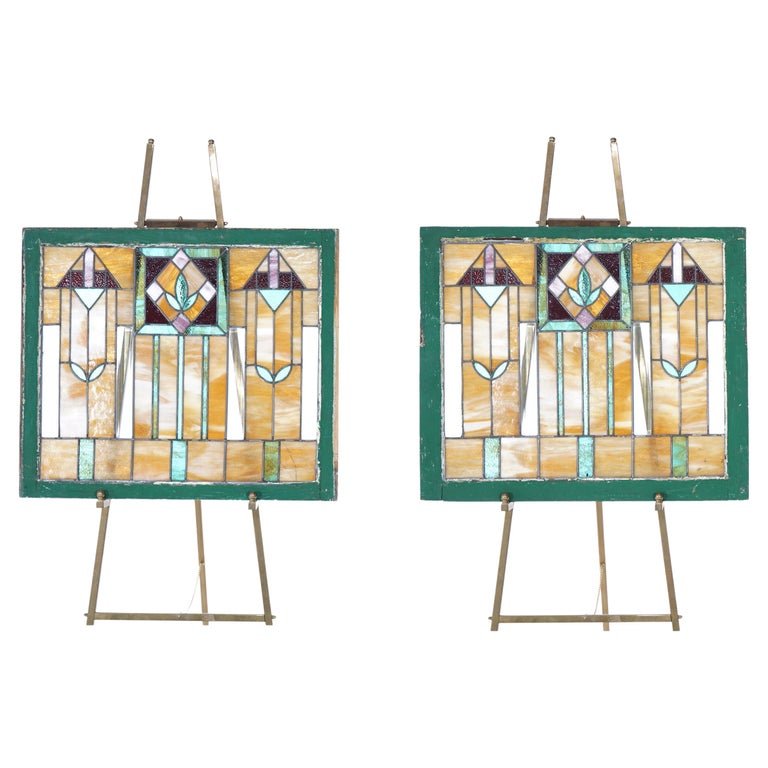Antique Pair of Frank Loyd Wright Arts & Crafts Leaded & Stained Glass Windows: An antique Arts and Crafts Prairie School windows in the manner of Frank Lloyd Wright offer leaded stained glass construction with geometric design, seated in wood sash, c1910. Measure - 26.5"h x 31"w