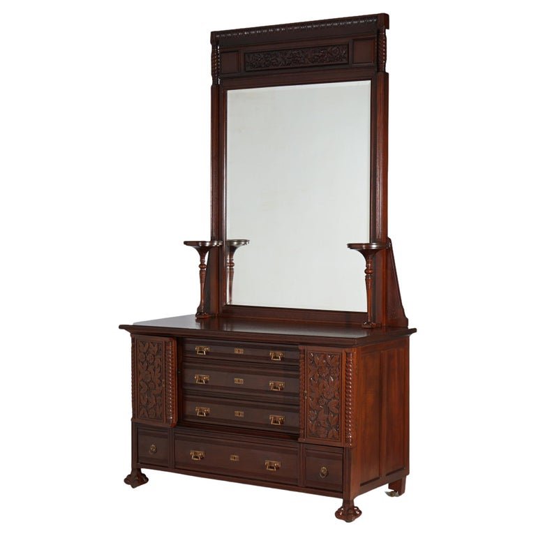 Antique Aesthetic 90" Carved Mahogany Dresser with Mirror, circa 1890: An antique Aesthetic Movement dresser offer mahogany construction with mirror having foliate carved crest and flanking candle stands over chest with central drawer tower having flanking cabinets over 