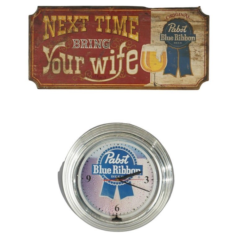 2 Advertising Pcs - Pabst Blue Ribbon Wood Sign & Wall Clock: 2 Advertising Pcs - Pabst Blue Ribbon Wood Sign & Wall Clock. Measures - PBR: 14.5"h x 14.5"w x 2.5"d; Wood: 23.75"h x 11"w x 1"d. *** OPTIONAL SHIPPING & DELIVERY - While onsite retrieval is always w