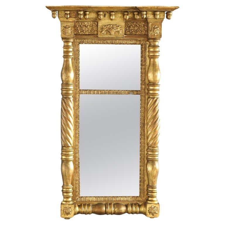 Antique Classical American Empire Giltwood Wall Mirror 19th C: An antique American Empire Classical wall mirror offers giltwood frame with crest having drop acorn form finials over flanking columns, foliate and floral elements, en verso "J. S. Brow.." , 19th cent