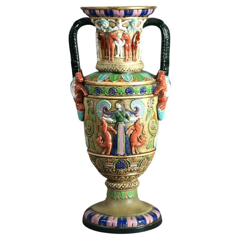 Antique Egyptian Revival Majolica Amphora Teplitz Pottery Vase C1910: An antique Egyptian Revival vase offers Majolica Amphora Teplitz pottery construction with enameled decoration, horses and figures, signed on base as photographed, c1910Vase C1910. Measures- 18''H x 8