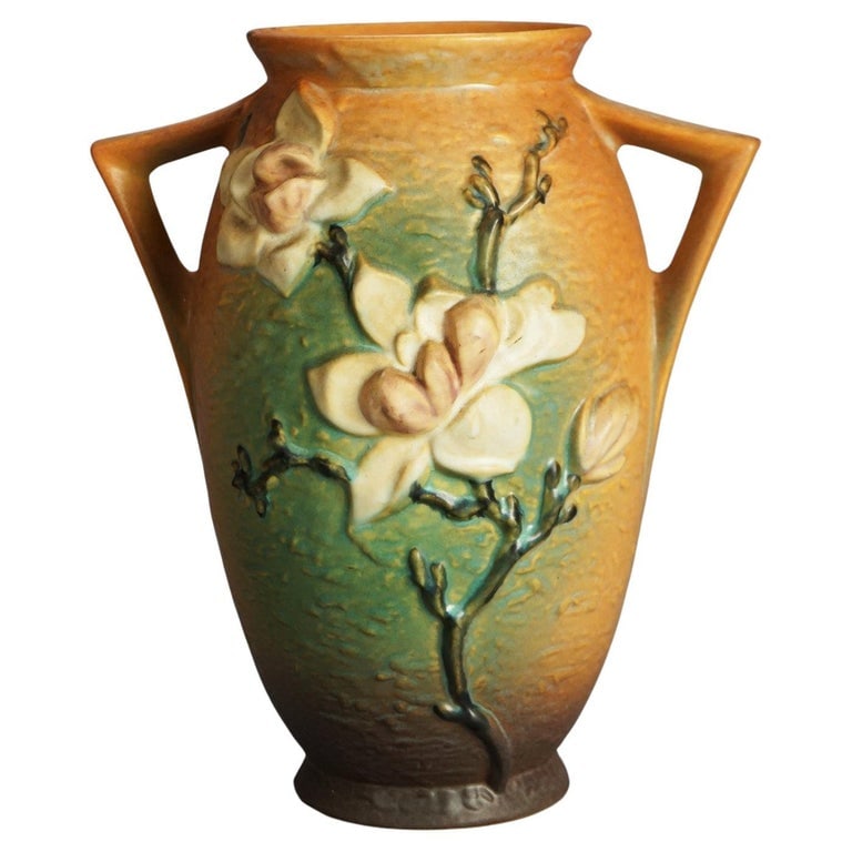 Roseville Art Pottery Brown Vase with Magnolia Pattern Mid 20thC: Roseville Art Pottery Brown Vase with Magnolia Pattern Mid 20thC. Measures - 12.5"h x 10.5"w x 8"d. *** OPTIONAL SHIPPING & DELIVERY - While onsite retrieval is always welcome at no charge, we offer I