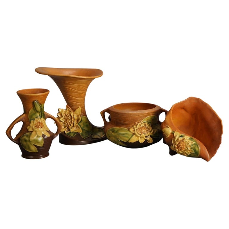 Four Pieces of Brown Roseville Art Pottery with Water Lily Pattern Mid 20thC: Four Pieces of Brown Roseville Art Pottery with Water Lily Pattern Mid 20thC. Measures - 7.75"h x 8"w x 7"d (cornucopia). *** OPTIONAL SHIPPING & DELIVERY - While onsite retrieval is always welcome at