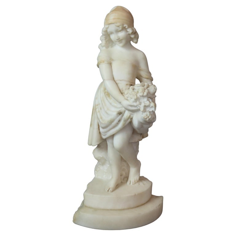 16" Carved Alabaster Sculpture Statue of a Young Girl with a Bouquet c1890: An antique carved alabaster sculpture of a young girl with a bouquet of flowers in countryside setting, circa 1890. Measures - 16"h x 7.25"w x 7"d. *** OPTIONAL SHIPPING & DELIVERY - While onsite retr
