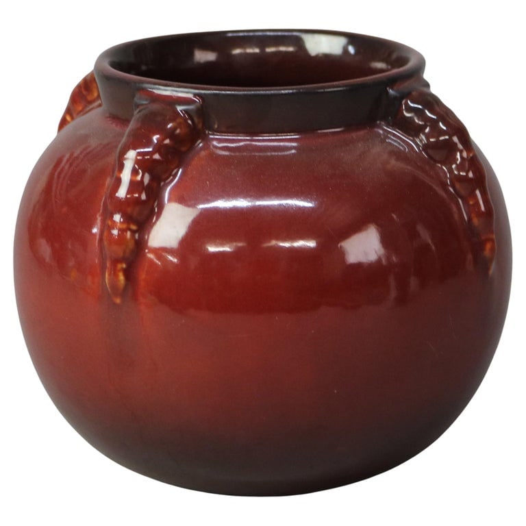 Roseville Art Pottery Topeo Red Claw Vase Mid 20thC: Roseville Art Pottery Topeo Red Claw Vase Mid 20thC. A striking example of Roseville Art Pottery, this Topeo Red Claw Vase features a rich, deep red glaze with distinctive claw-like embellishments. Or