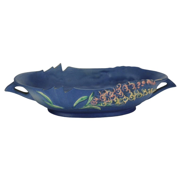 Roseville Art Pottery Blue Console Bowl With Foxglove Pattern Mid 20thC: Roseville Art Pottery Blue Console Bowl With Foxglove Pattern Mid 20thC. Measures- 3.5"H x 15.25"W x 7.75"D. A beautifully crafted Roseville Art Pottery console bowl featuring the iconic Foxglove patt