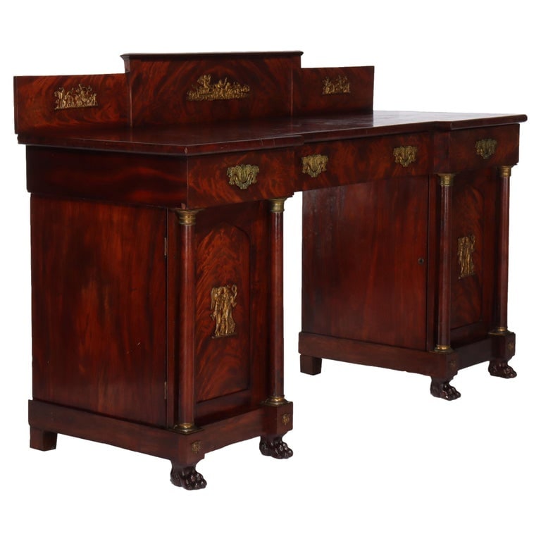Boston Period Napoleonic Flame Mahogany Double Pedestal Sideboard c1820: This elegant antique bookcase from the Boston Period, circa 1820, showcases exquisite craftsmanship with its flame mahogany construction. The piece features double pedestal design and is adorned with