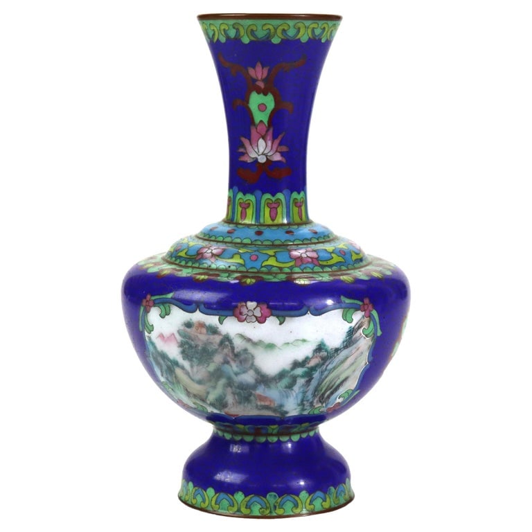 Antique Cloisonne Vase with Landscape Scene & Floral Elements C1920: A finely crafted antique cloisonné vase from circa 1920, featuring intricate scenic landscape and floral decoration. The vase showcases vibrant colors with a dominant blue background, accented by gre